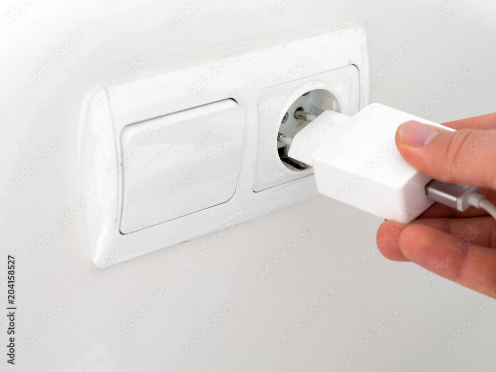 Fototapeta premium phone charger on the wall at home