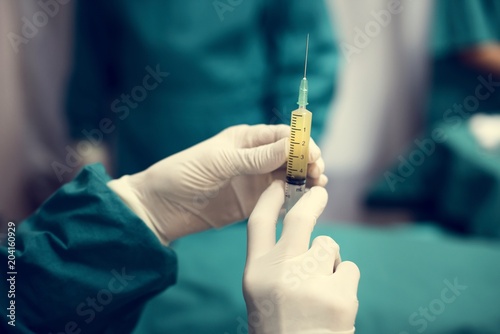 Doctor preparing a syringe shot