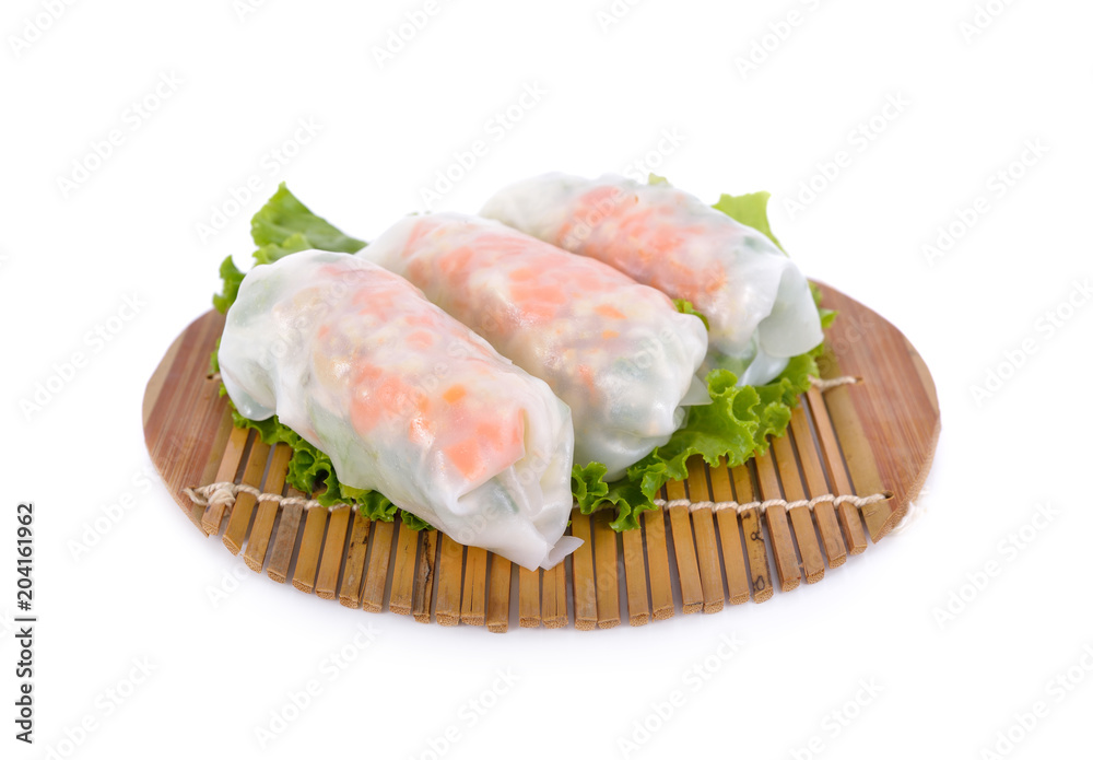 noodle roll with pork, cabbage, carrot on wooden mat and on white background noodle roll with pork, cabbage, carrot on wooden mat and on white background