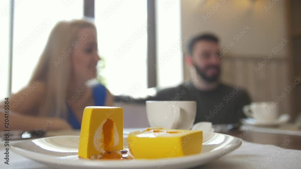 Sweet dessert in front of couple talking at the cafe Sweet dessert in front of couple talking at the cafe