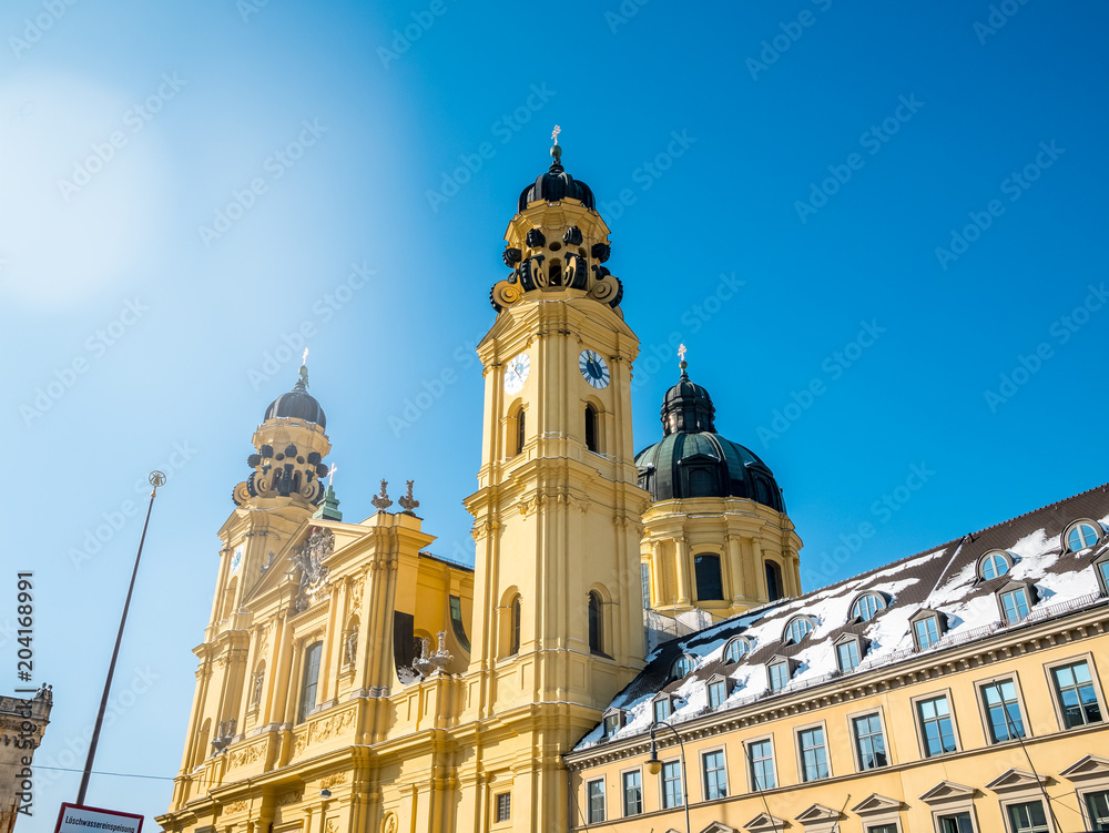 feldherrnhalle and tower of theatinerkirche theatinerchurch at odeon square odeonplatz in munich city bavaria germany tower clock time detail landscape orientation.Winter season Germany.