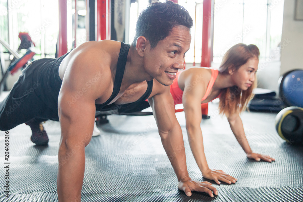 Man and woman doing push ups 