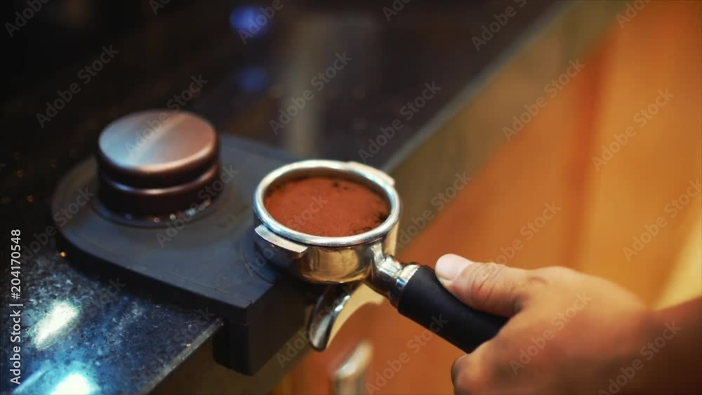 Making Ground Coffee with Tamping fresh coffee. CloseUp. Making coffee from start to finish