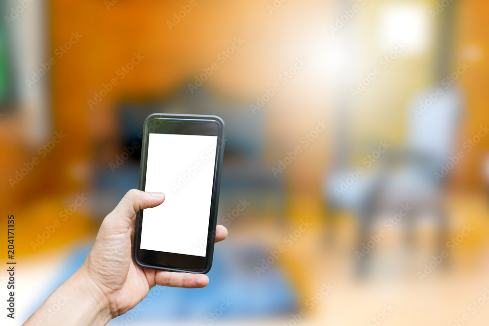 Hand hold on mobile with house background Hand hold on mobile with house background