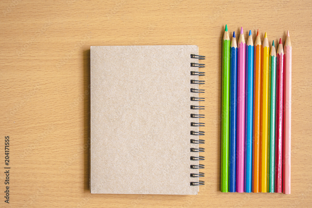 Notepad with pencil on wood board Notepad with pencil on wood board