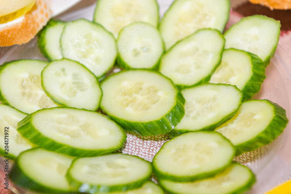 Salted cucumbers. Slices of cucumbers on the table. Sliced cucumber. Salted cucumbers. Slices of cucumbers on the table. Sliced cucumber.
