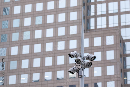 Camera tower in front of skyscraper