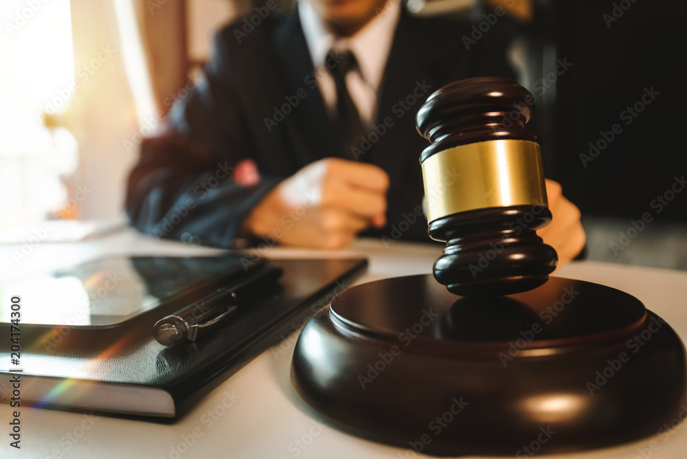 Justice and law concept.Male judge in a courtroom with the gavel,working with,digital tablet computer docking keyboard,eyeglasses,on wood table
Justice and law concept.Male judge in a courtroom with the gavel,working with,digital tablet computer docking keyboard,eyeglasses,on wood table