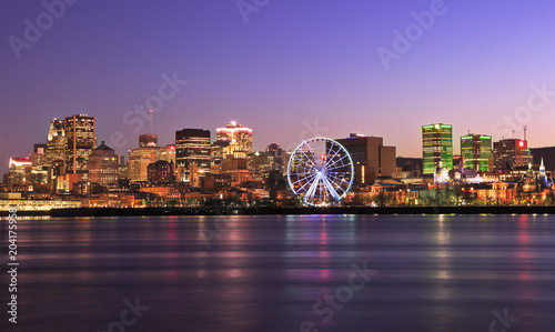 Montreal skyline at dusk and Saint Lawrence River in Quebec, Canada photo