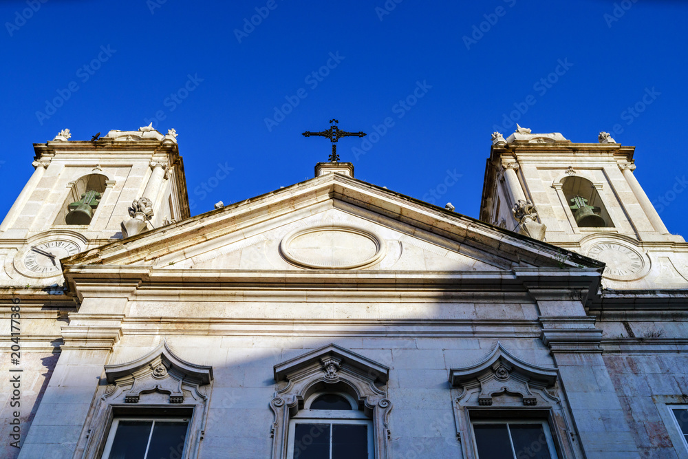 Close up particulare of facade of the church  in Lisbon . Blue sky background