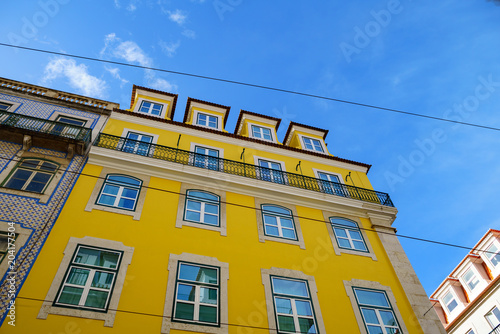 Bright colorful facade of old European building with windows .