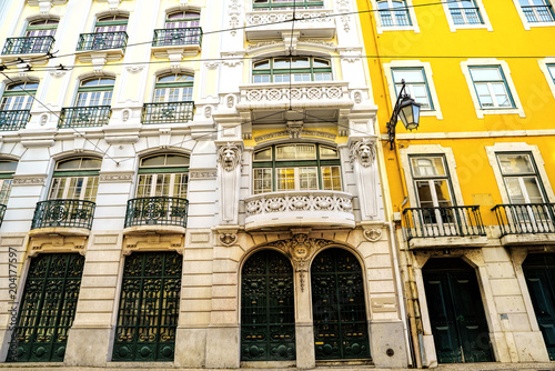 Bright colorful facade of old European building with windows .