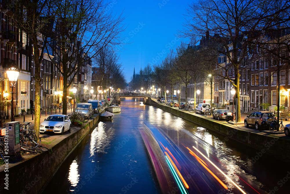 Amsterdam , view of Leidsegracht canal at night. It can be seen at center the bell friar of the Catholic Church