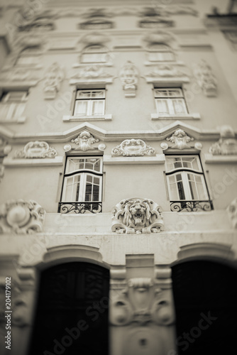 Bright colorful facade of old European building with windows .