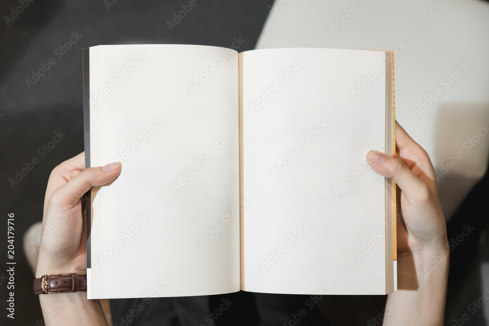 Young girl open the pages of the book empty. text for banner lifestyle and school. Young girl open the pages of the book empty. text for banner lifestyle and school.