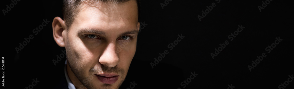 Fototapeta premium Tricky sly man face in dark room