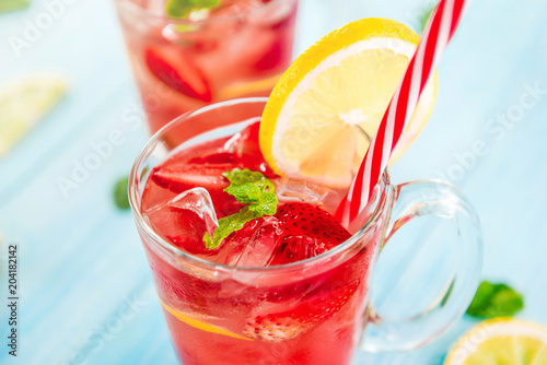 Strawberry lemonade juice with ice cubes in the glasses