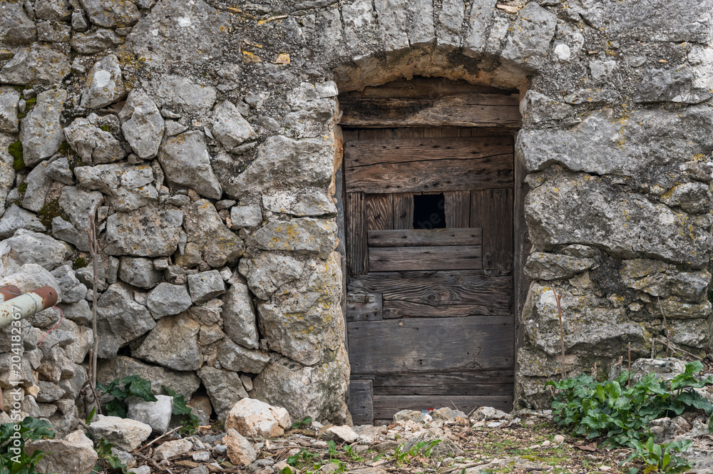 Very old weathered brown door made of wood