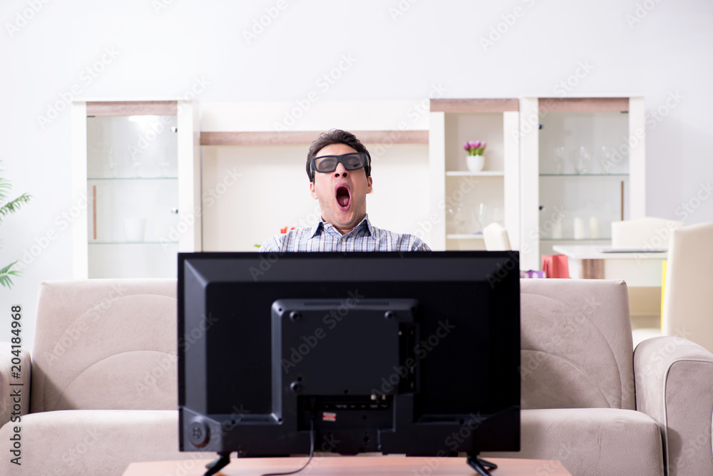 Man watching 3d tv at home Man watching 3d tv at home