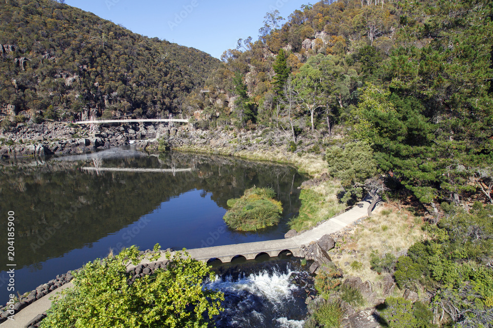 The first basin at Cataract Gorge with Alexandria footbridge over South Esk River in Launceston, Tasmania. A beautiful and relaxing area for families and tourists to explore.