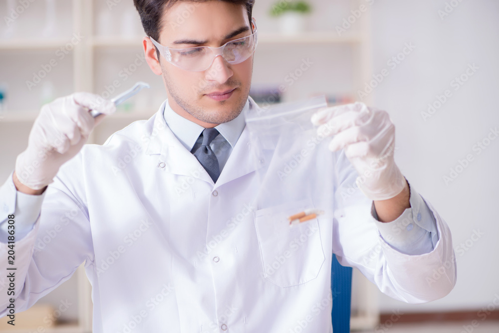 Expert criminologist working in the lab for evidence Expert criminologist working in the lab for evidence