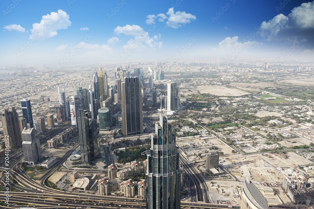 Fototapeta premium Aerial view of the Emirate of Dubai with blue sky over the desert
