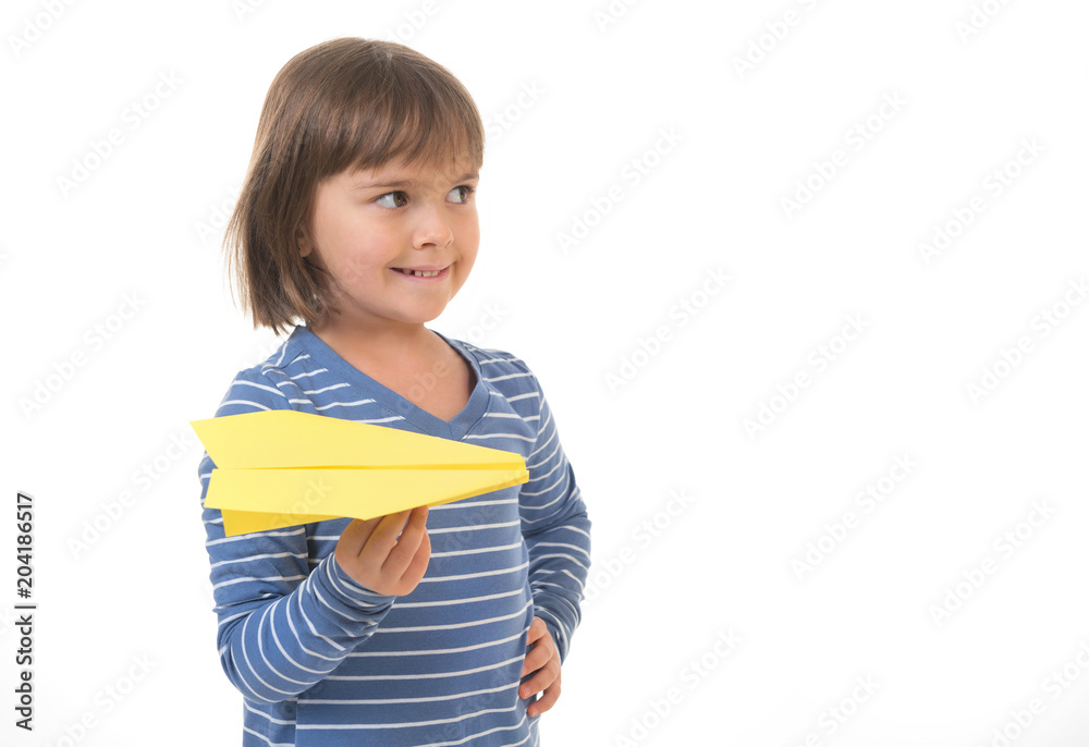 Little girl holding a paper airplane in a hand. Isolated on a white background. Little girl holding a paper airplane in a hand. Isolated on a white background.