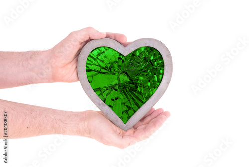 Adult holding heart filled with a large green ruby