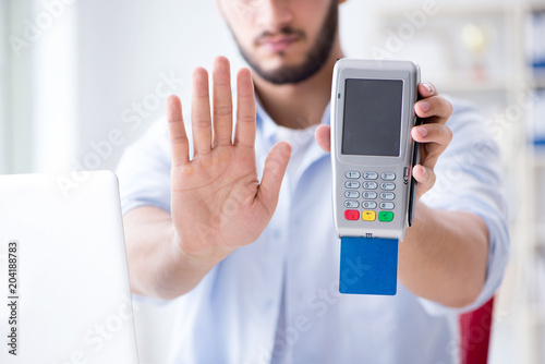 Man processing credit card transaction with POS terminal