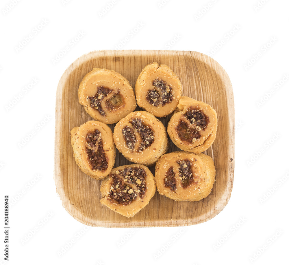 Indian Fried Bhakarwadi Tea Time Snack also known as bakarwadi, bakarvadi, bakar vadi, bakar wadi or spring roll is a traditional spicy Maharashtra and Gujarat Snack isolated on White Background