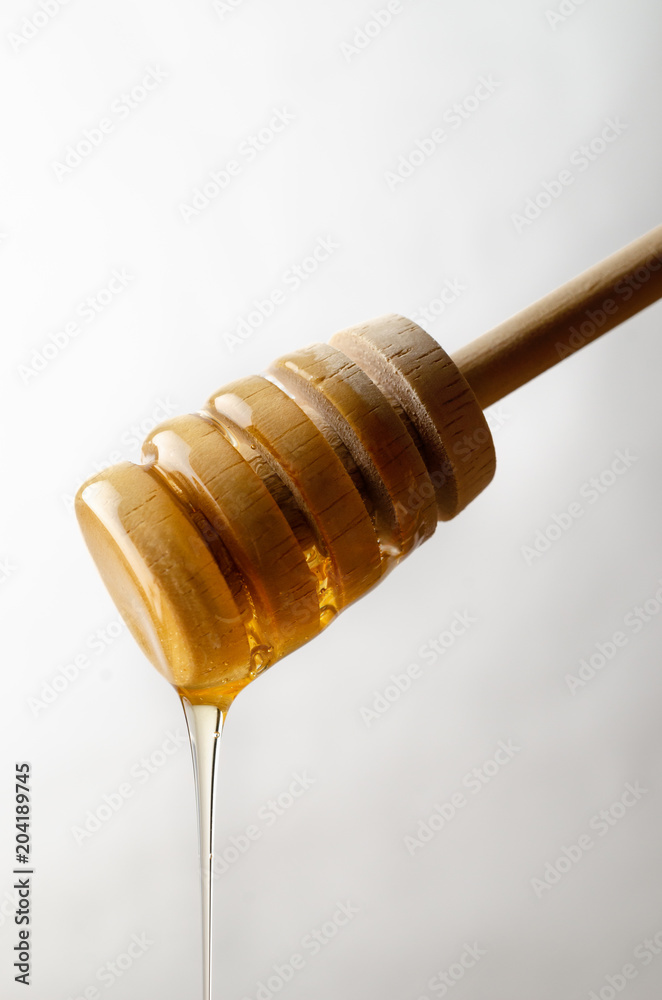 Honey Dripping from Wooden Drizzler Honey Dripping from Wooden Drizzler
