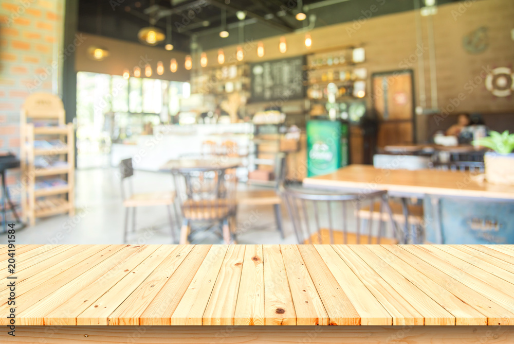 Empty wooden table and Blur coffee shop or cafe restaurant for product placement. Empty wooden table and Blur coffee shop or cafe restaurant for product placement.