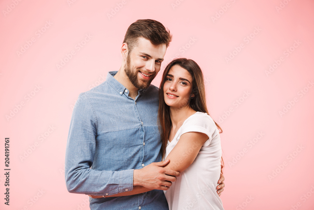 Portrait of a smiling young couple hugging Portrait of a smiling young couple hugging