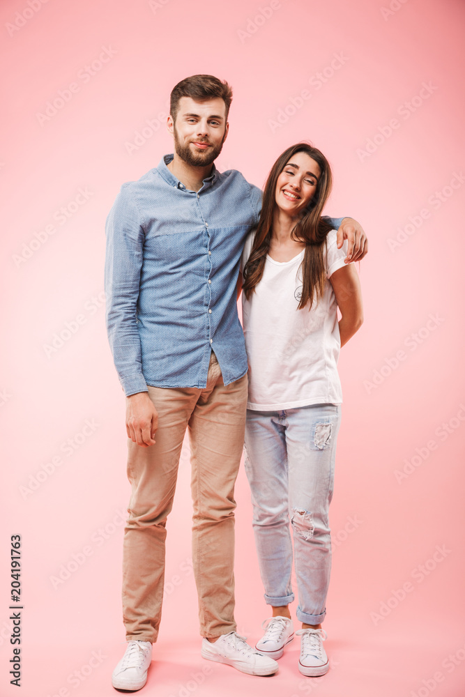 Full length portrait of a smiling young couple hugging Full length portrait of a smiling young couple hugging
