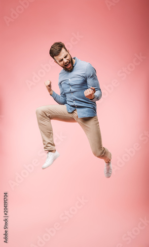 Full length of a satisfied young man jumping