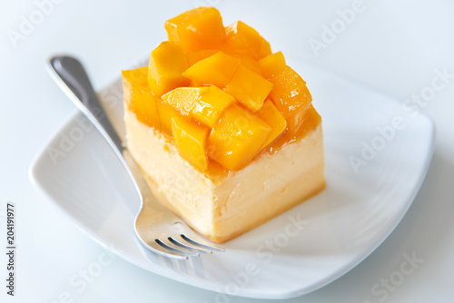 Wallpaper Mural Slice of delicious Mango cheesecake on white plate. Torontodigital.ca