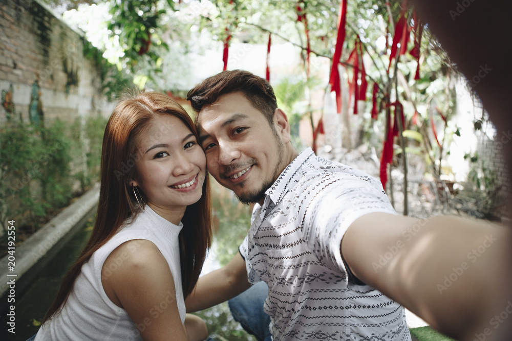 Fototapeta premium Happy couple taking selfie together