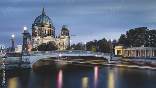 Berlin Cathedral on the Spree River with passing excursion steamer, light traces, dusk, Berlin, Germany, Europe photo