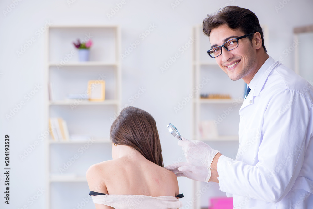 Fototapeta premium Doctor examining the skin of female patient