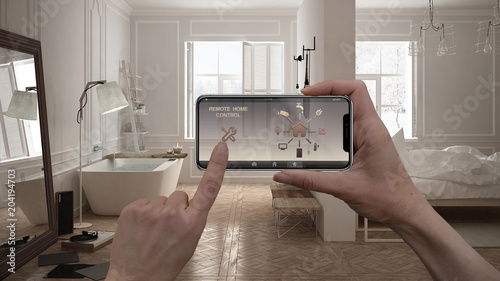 Remote home control system on a digital smart phone tablet. Device with app icons. Interior of minimalist white bathroom in the background, architecture design.