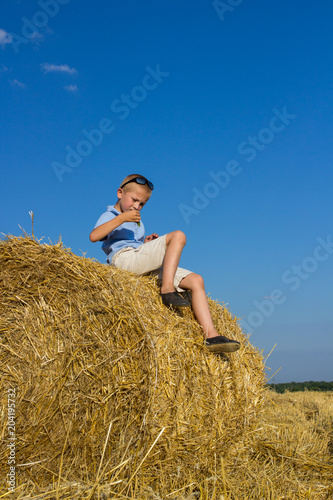 haystack sitting boy