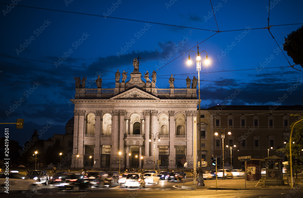 Rome - July 2017: people and cars on Rome street at night in July 2017 in Rome , Italy .