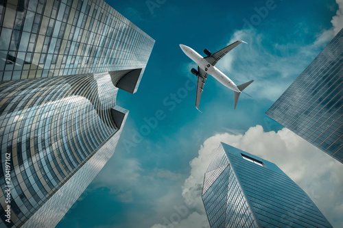 Airlane flying over modern glass and steel office buildings near