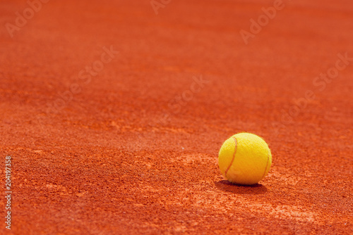 Tennis ball on clay court © Bits and Splits