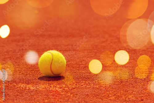 Tennis ball on clay court © Bits and Splits