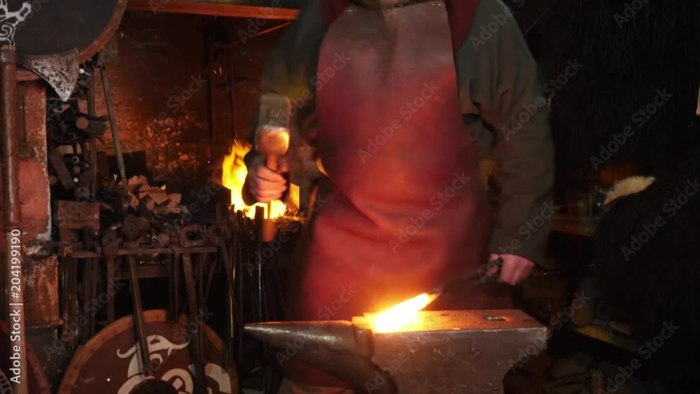 The smith viking working hard in a smithy The smith viking working hard in a smithy