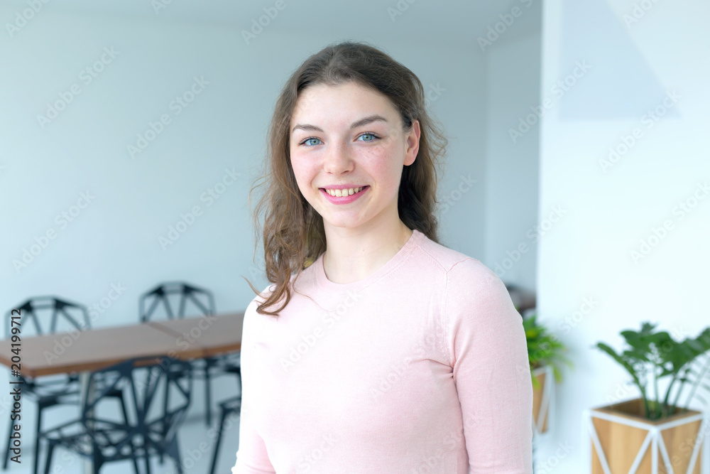 Portrait of a young woman in a bright room. Portrait of a young woman in a bright room.
