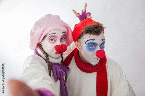 emotional mime guy and girl take pictures of themselves on the phone. Human emotions