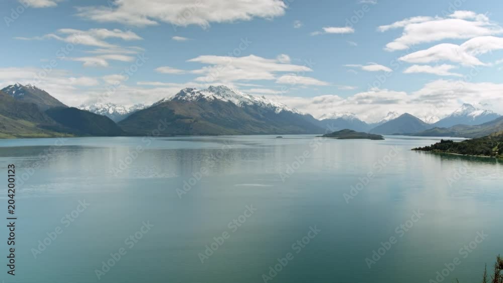 Tilting down from sky to alpine mountains and lake, Queenstown, New Zealand Tilting down from sky to alpine mountains and lake, Queenstown, New Zealand
