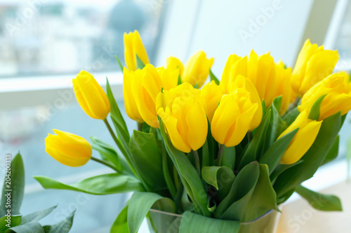 Fototapeta Naklejka Na Ścianę i Meble -  Large bouquet of yellow tulips. Flowers in the room near the window.